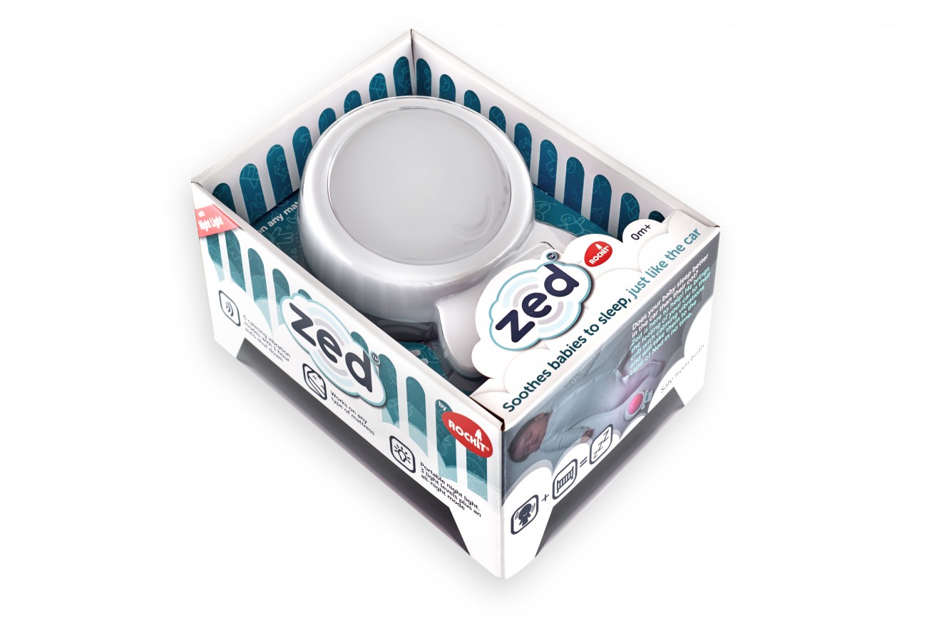 A baby soothing device called Zed in it's packaging. Packaging includes a Rockit logo and the words 'Soothes babies to sleep, just like in the car"